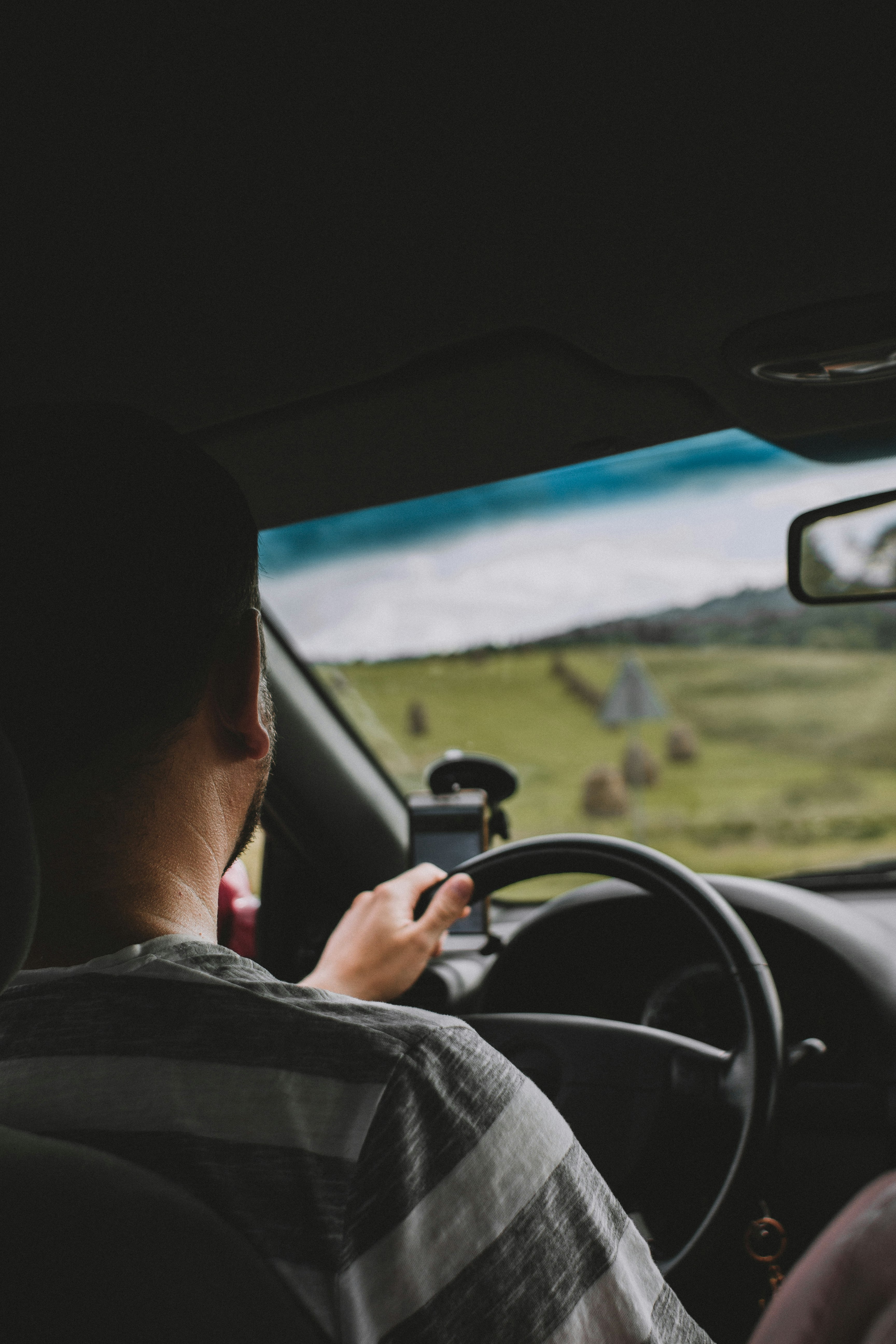 man driving car during daytime